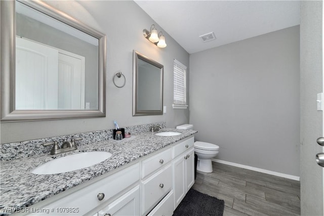 138 Stone Dr, Roland, OK 74954 - full bath with baseboards, visible vents, a sink, and toilet