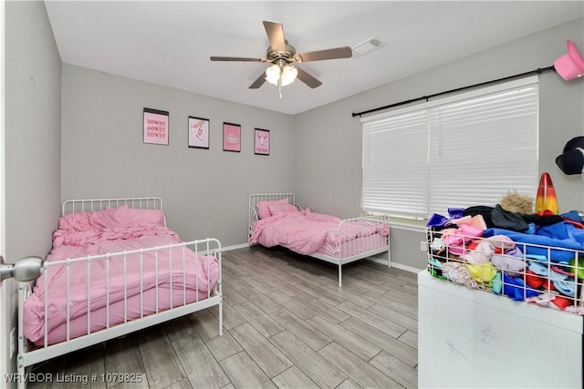 138 Stone Dr, Roland, OK 74954 - bedroom with baseboards, visible vents, ceiling fan, and wood finished floors