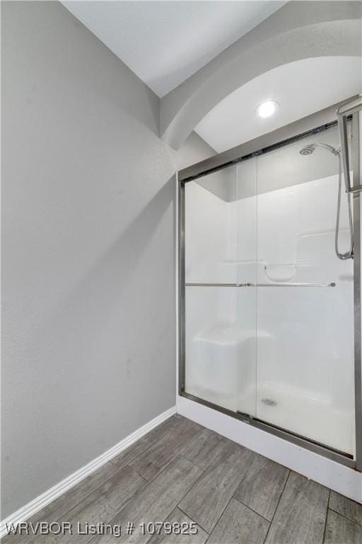138 Stone Dr, Roland, OK 74954 - bathroom featuring wood finish floors, baseboards, and a shower stall