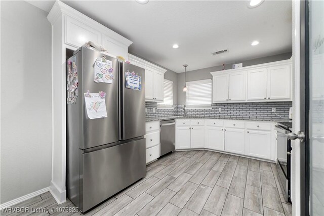 138 Stone Dr, Roland, OK 74954 - kitchen featuring white cabinetry, stainless steel appliances, tasteful backsplash, and visible vents