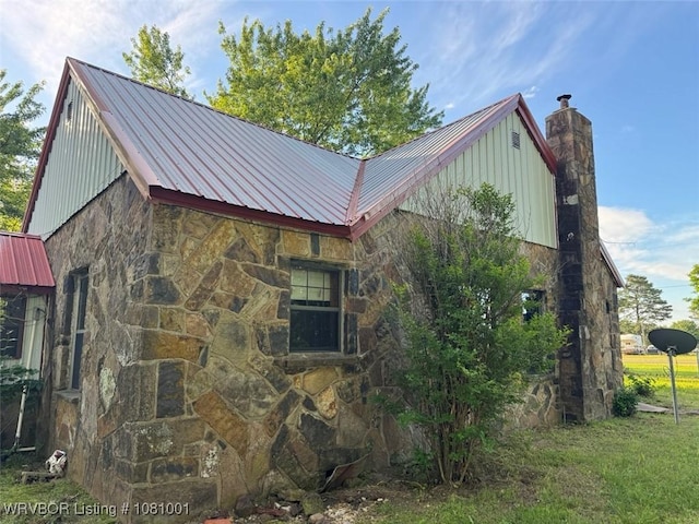 464085 E 1020th Rd, Sallisaw, OK 74955 - view of side of home featuring stone siding, metal roof, a chimney, and board and batten siding
