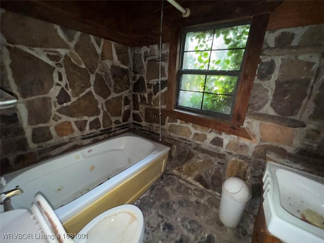 464085 E 1020th Rd, Sallisaw, OK 74955 - bathroom with toilet, a tub with jets, and stone flooring