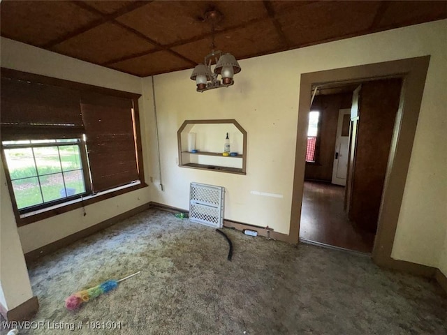 464085 E 1020th Rd, Sallisaw, OK 74955 - unfurnished dining area featuring a chandelier, carpet, and baseboards