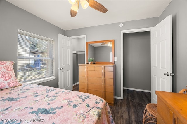 bedroom with baseboards, ceiling fan, and dark wood finished floors