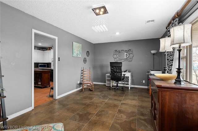 sitting room featuring a textured ceiling