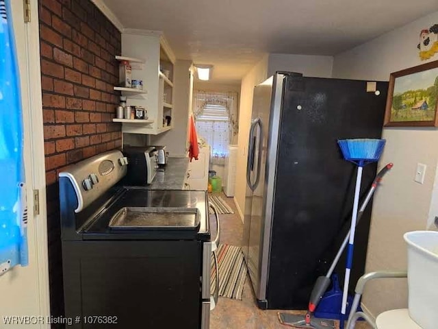 kitchen with appliances with stainless steel finishes and brick wall