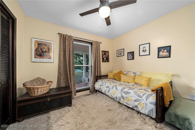 bedroom with ceiling fan, light colored carpet, and a closet