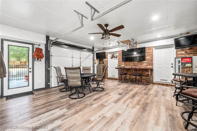 dining space with ceiling fan and light wood-type flooring