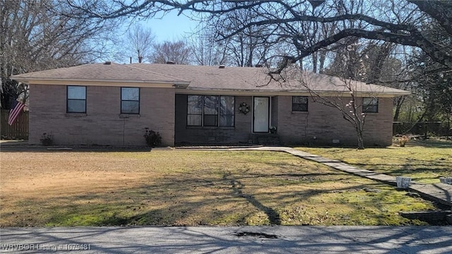 single story home with a front yard, brick siding, roof with shingles, and crawl space