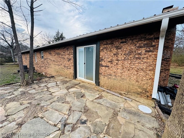 39668 S Barton, Fanshawe, OK 74935 - rear view of property with a patio and brick siding