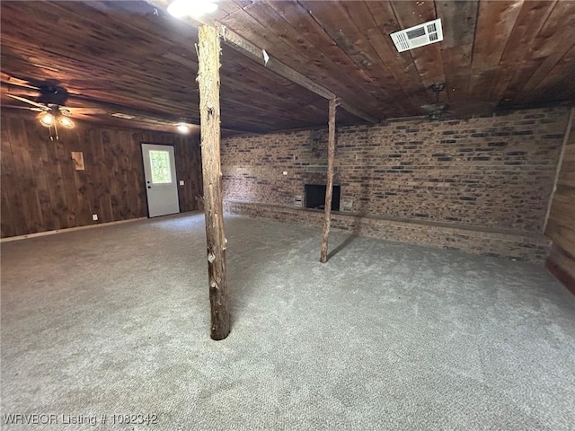 39668 S Barton, Fanshawe, OK 74935 - below grade area featuring wood ceiling, a ceiling fan, carpet flooring, brick wall, and wooden walls