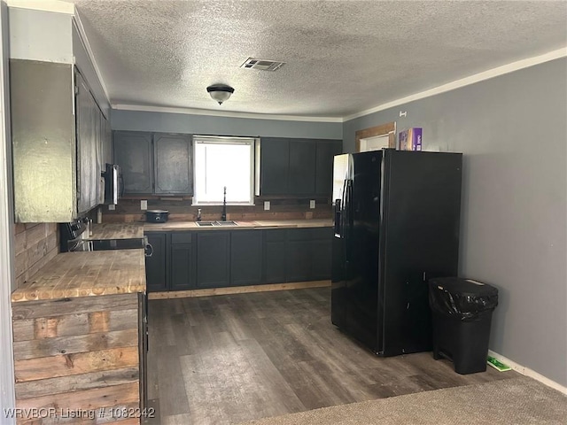 39668 S Barton, Fanshawe, OK 74935 - kitchen with black refrigerator with ice dispenser, stainless steel microwave, a textured ceiling, dark wood-type flooring, and electric range