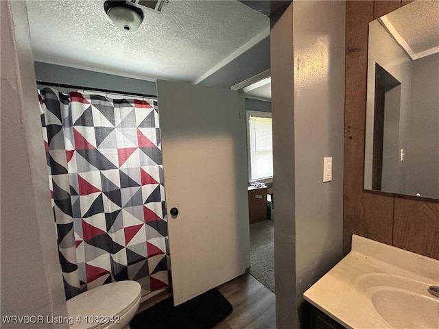 39668 S Barton, Fanshawe, OK 74935 - full bathroom with a textured ceiling, wood finished floors, vanity, and a shower with shower curtain