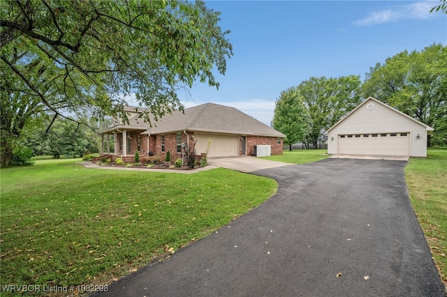 6721 Dean Rd, Alma, AR 72921 - view of front facade with brick siding, a front lawn, a garage, and an outdoor structure