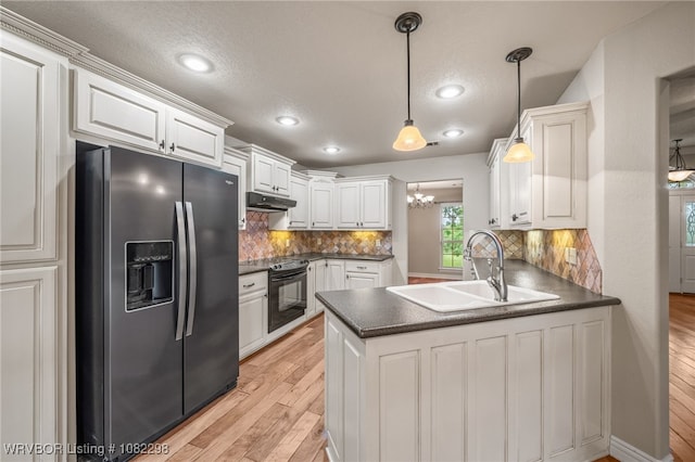 6721 Dean Rd, Alma, AR 72921 - kitchen with stainless steel fridge, electric range, dark countertops, under cabinet range hood, and a peninsula