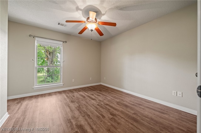 6721 Dean Rd, Alma, AR 72921 - empty room with wood finished floors, a ceiling fan, and a textured ceiling