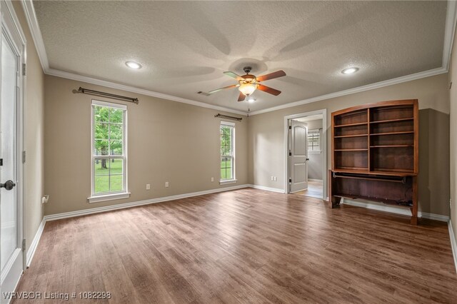 6721 Dean Rd, Alma, AR 72921 - unfurnished room with a textured ceiling, ceiling fan, healthy amount of natural light, wood finished floors, and crown molding