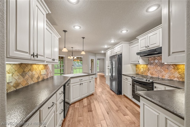 6721 Dean Rd, Alma, AR 72921 - kitchen featuring stainless steel fridge with ice dispenser, under cabinet range hood, black electric range oven, dark countertops, and a peninsula