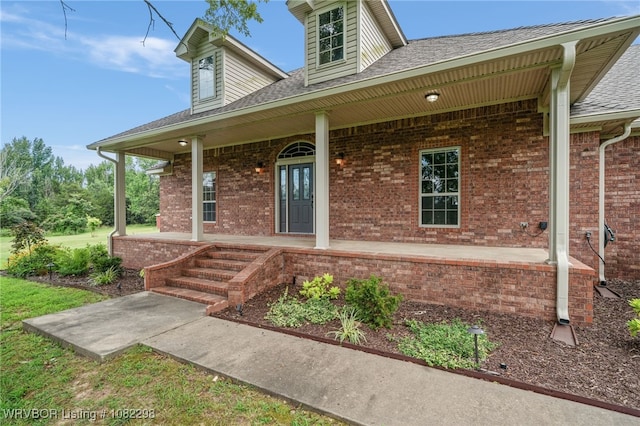 6721 Dean Rd, Alma, AR 72921 - view of exterior entry with covered porch, brick siding, and roof with shingles