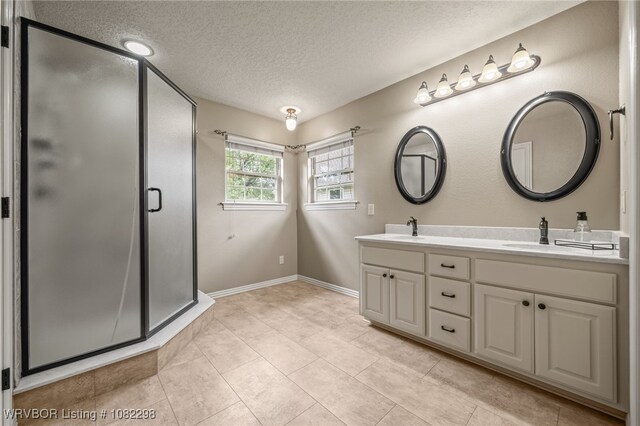 6721 Dean Rd, Alma, AR 72921 - full bathroom featuring double vanity, a textured ceiling, a stall shower, and tile patterned flooring