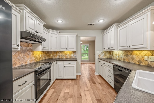 6721 Dean Rd, Alma, AR 72921 - kitchen featuring under cabinet range hood, black appliances, light wood-type flooring, dark countertops, and white cabinets