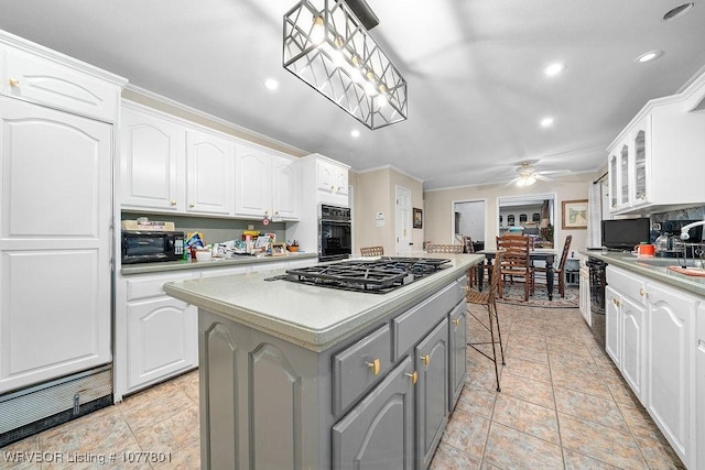 kitchen featuring gray cabinets, a center island, black appliances, light countertops, and white cabinets