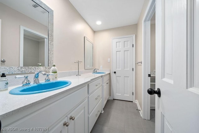full bath with tile patterned flooring, a sink, double vanity, and visible vents
