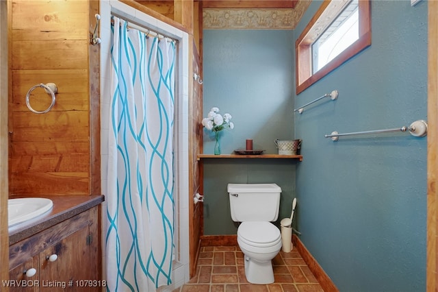 bathroom featuring baseboards, toilet, curtained shower, tile patterned flooring, and vanity