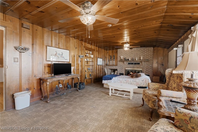 bedroom with wood walls, a brick fireplace, and wood ceiling