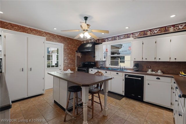 kitchen with dark countertops, black appliances, range hood, and a healthy amount of sunlight