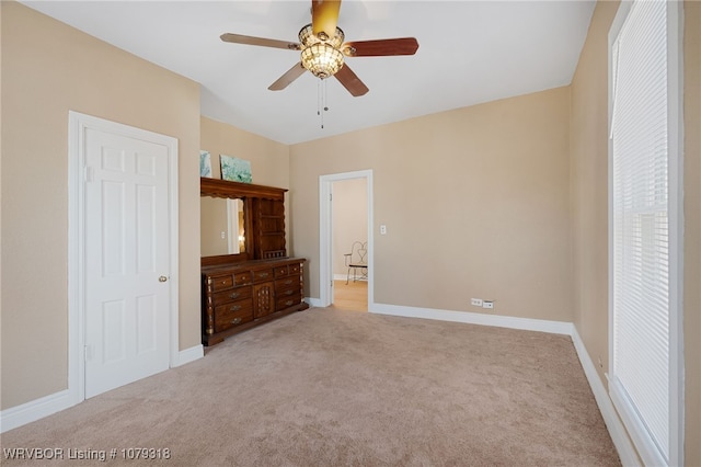 unfurnished bedroom featuring ceiling fan, carpet flooring, and baseboards