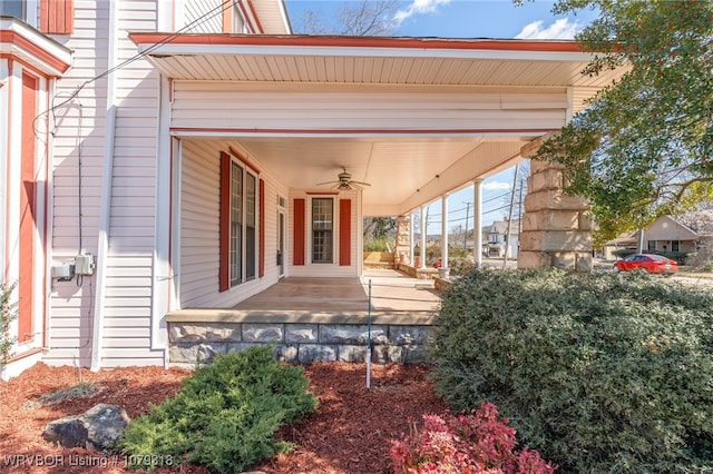 entrance to property with a ceiling fan and covered porch