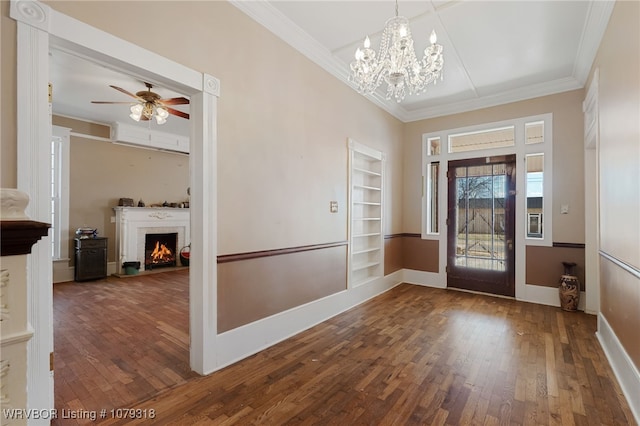 entryway with baseboards, a brick fireplace, hardwood / wood-style flooring, and crown molding