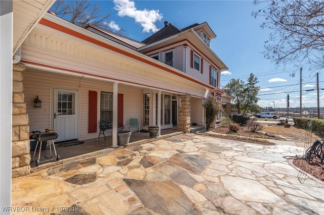 back of property with covered porch