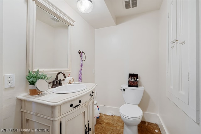 bathroom featuring baseboards, visible vents, toilet, tile patterned floors, and vanity