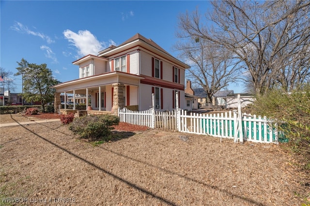 view of property exterior with a fenced front yard and a porch