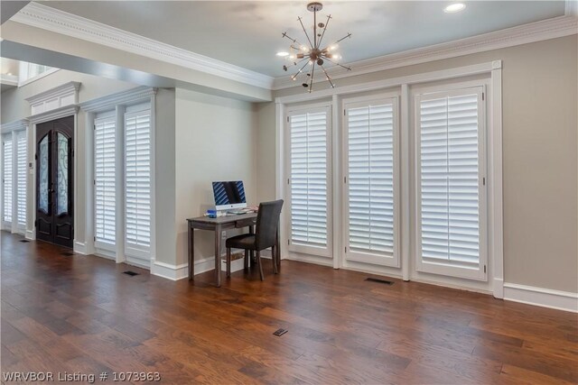 office space with dark hardwood / wood-style floors, ornamental molding, and an inviting chandelier