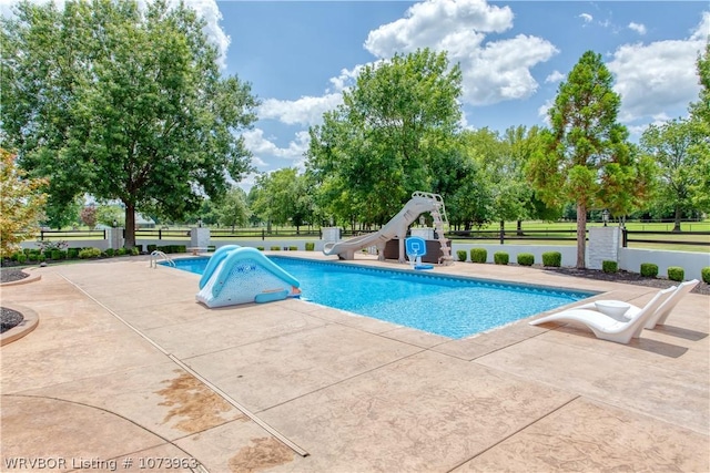 view of pool featuring a patio and a water slide