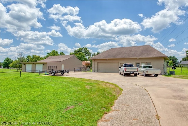 ranch-style home featuring a garage and a front lawn