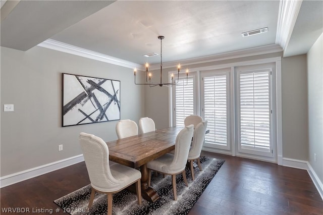 dining space with crown molding, dark hardwood / wood-style floors, and a notable chandelier