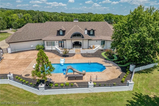 view of pool featuring a patio and a water slide