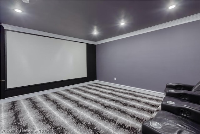 home theater room with crown molding and carpet