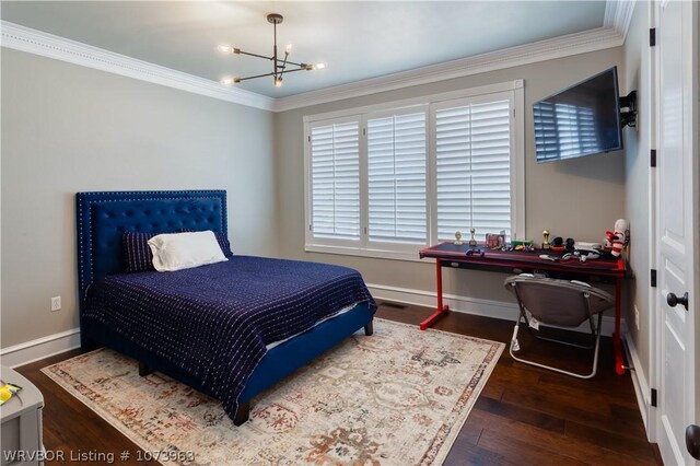 bedroom with dark hardwood / wood-style flooring, ornamental molding, and a notable chandelier