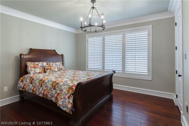 bedroom with dark hardwood / wood-style floors, crown molding, and a chandelier