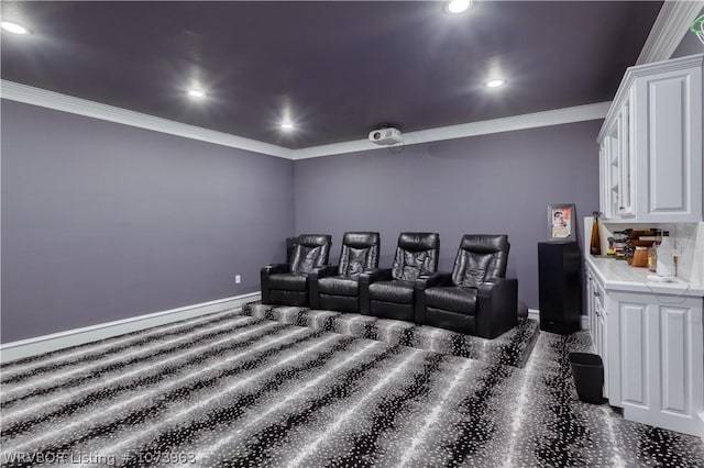 carpeted home theater featuring ornamental molding