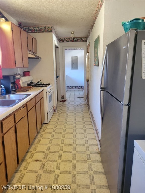113614 S 4640th Rd, Gans, OK 74936 - kitchen with freestanding refrigerator, white range with gas cooktop, light flooring, electric panel, and a sink