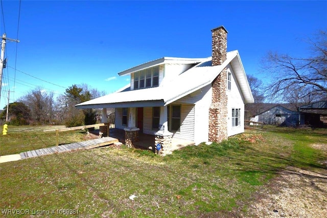1221 S 3rd St, Stilwell, OK 74960 - view of front facade with a chimney, a porch, and a front yard