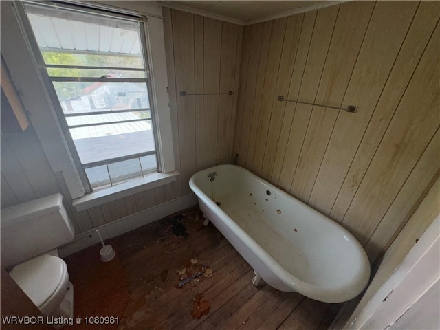 1221 S 3rd St, Stilwell, OK 74960 - bathroom with wood-type flooring, wood walls, a soaking tub, and toilet