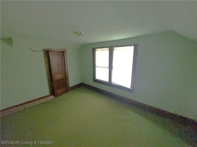 1221 S 3rd St, Stilwell, OK 74960 - additional living space with light colored carpet, baseboards, and lofted ceiling