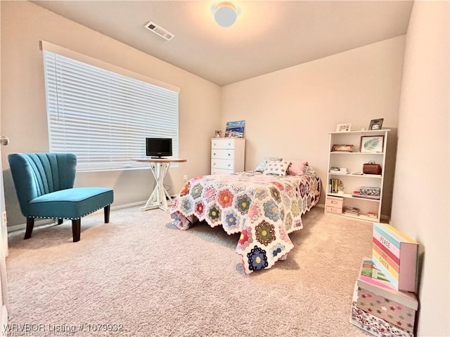 carpeted bedroom featuring visible vents